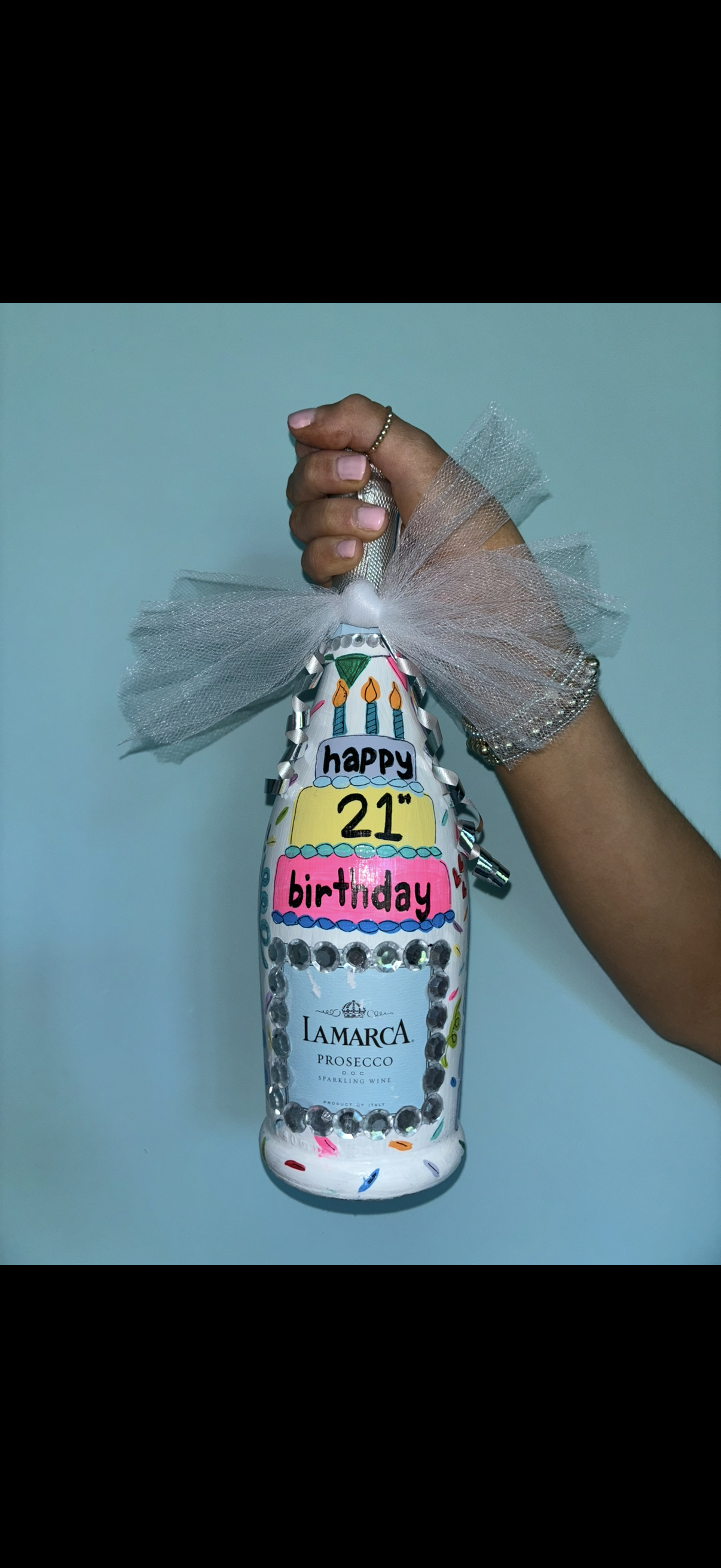Custom hand-painted Happy 21st Birthday champagne bottle with rhinestones and tulle bow